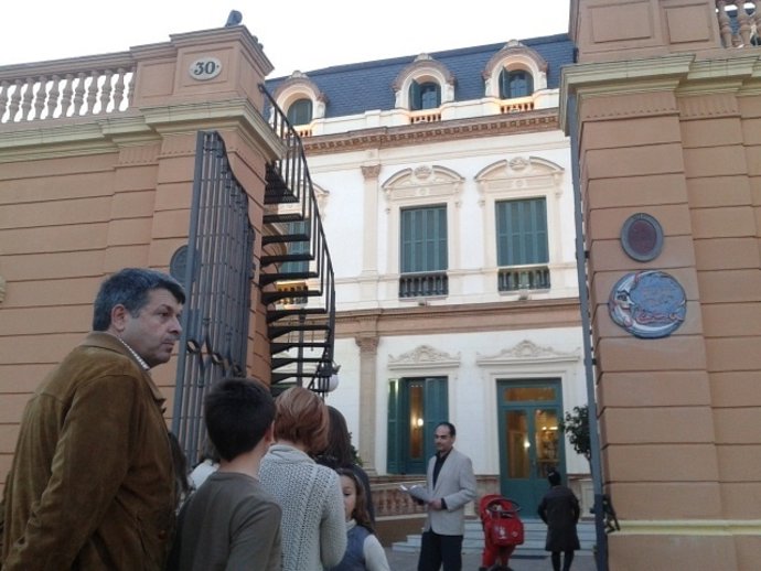 Personas esperando con sus hijos a las puertas del Centro Cívico Las Sirenas