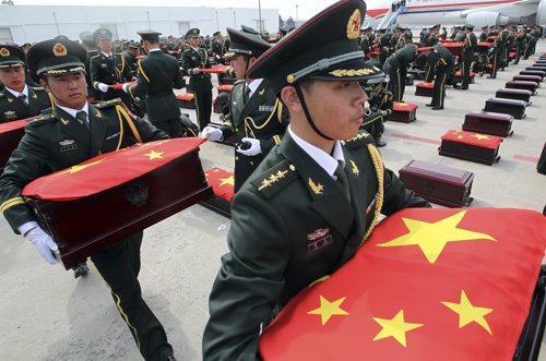 Soldados Chinos carga con los féretros de sus compatriotas muertos en la Guerra