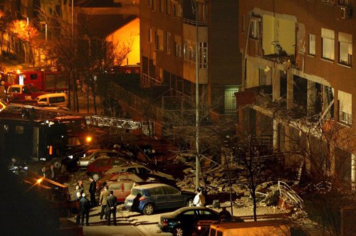POLICE AND RESCUE WORKERS INSPECT THE SCENE OF AN EXPLOSION NEAR MADRID.