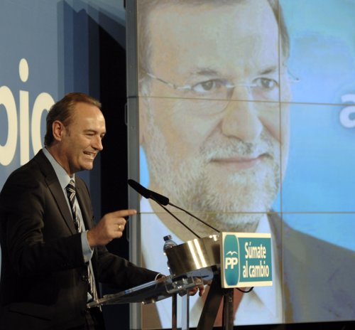 Alberto Fabra en una imagen de archivo con un video de Rajoy al fondo