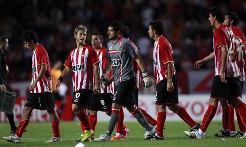 Players of Argentina's Estudiantes de La Plata leave the field at the end of the