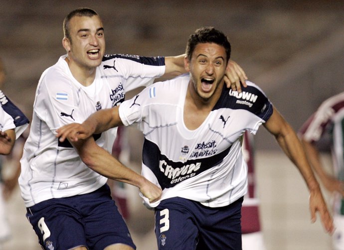 Herner of Gimnasia y Esgrima La Plata celebrates his goal with his team mate Sil