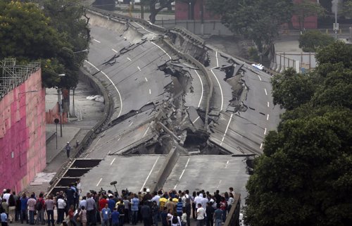 People gather to observe the Perimetral overpass, after its partial demolition a