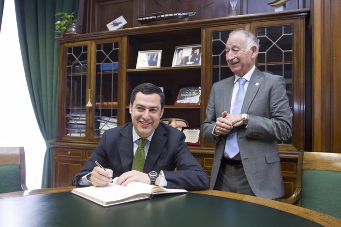 Moreno firma en el libro de honor de la Diputación junto a Amat