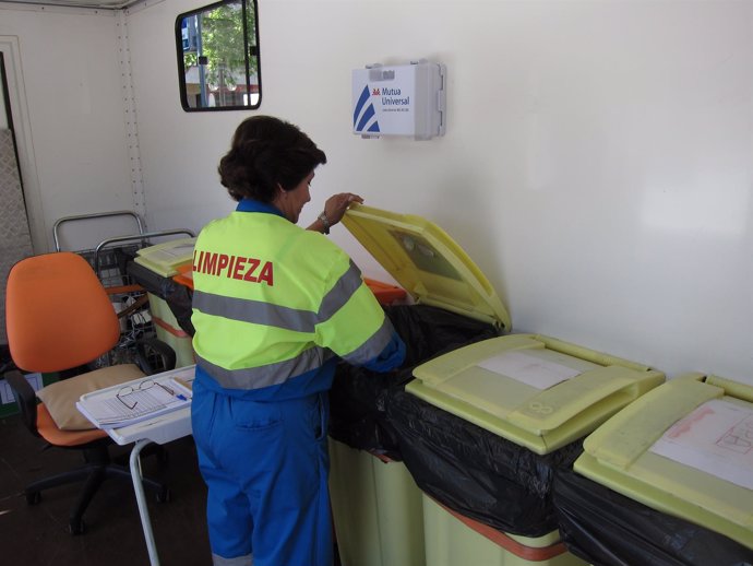 Una trabajadora del punto limpio manipula uno de los contenedores