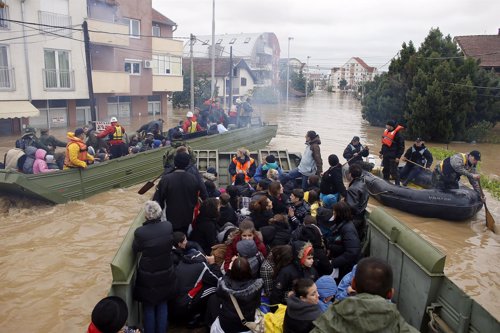 Serbian army soldiers evacuate people in amphibious vehicles in flooded town of 