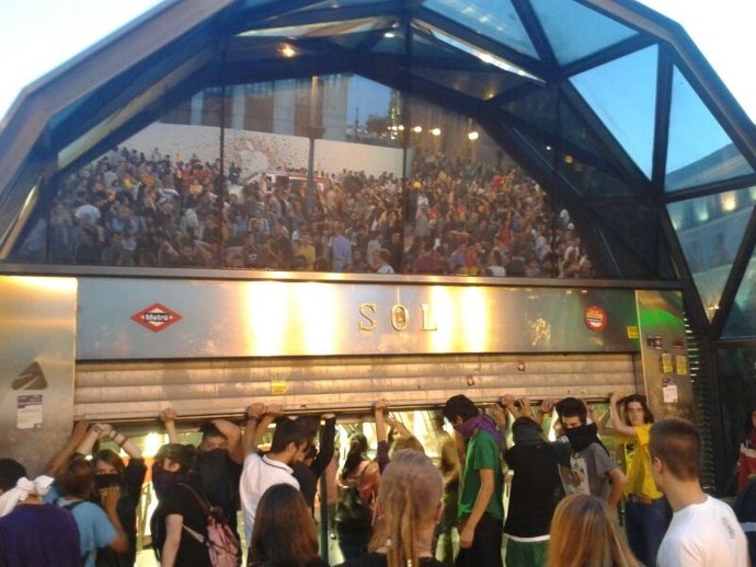 Jóvenes con el rostro cubierto en la Puerta del Sol