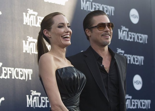 Angelina Jolie and actor Brad Pitt pose at the premiere 