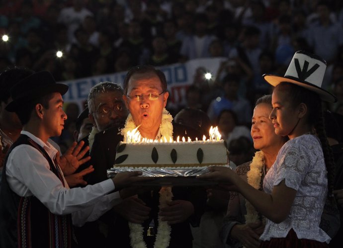 U.N. Secretary-General Ban blows the candles on a cake during a celebration for 