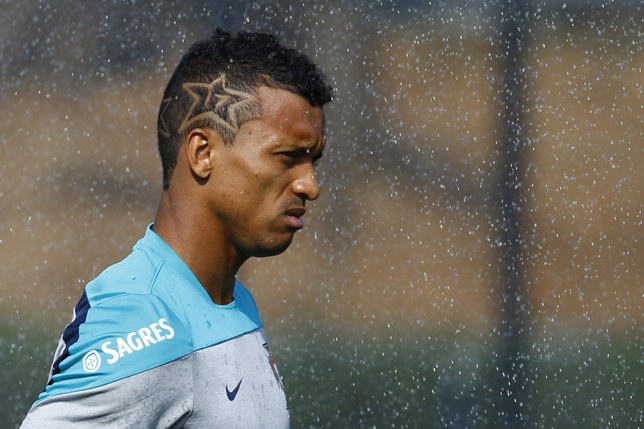 Portugal's Nani stands in the rain during a training session in Campinas