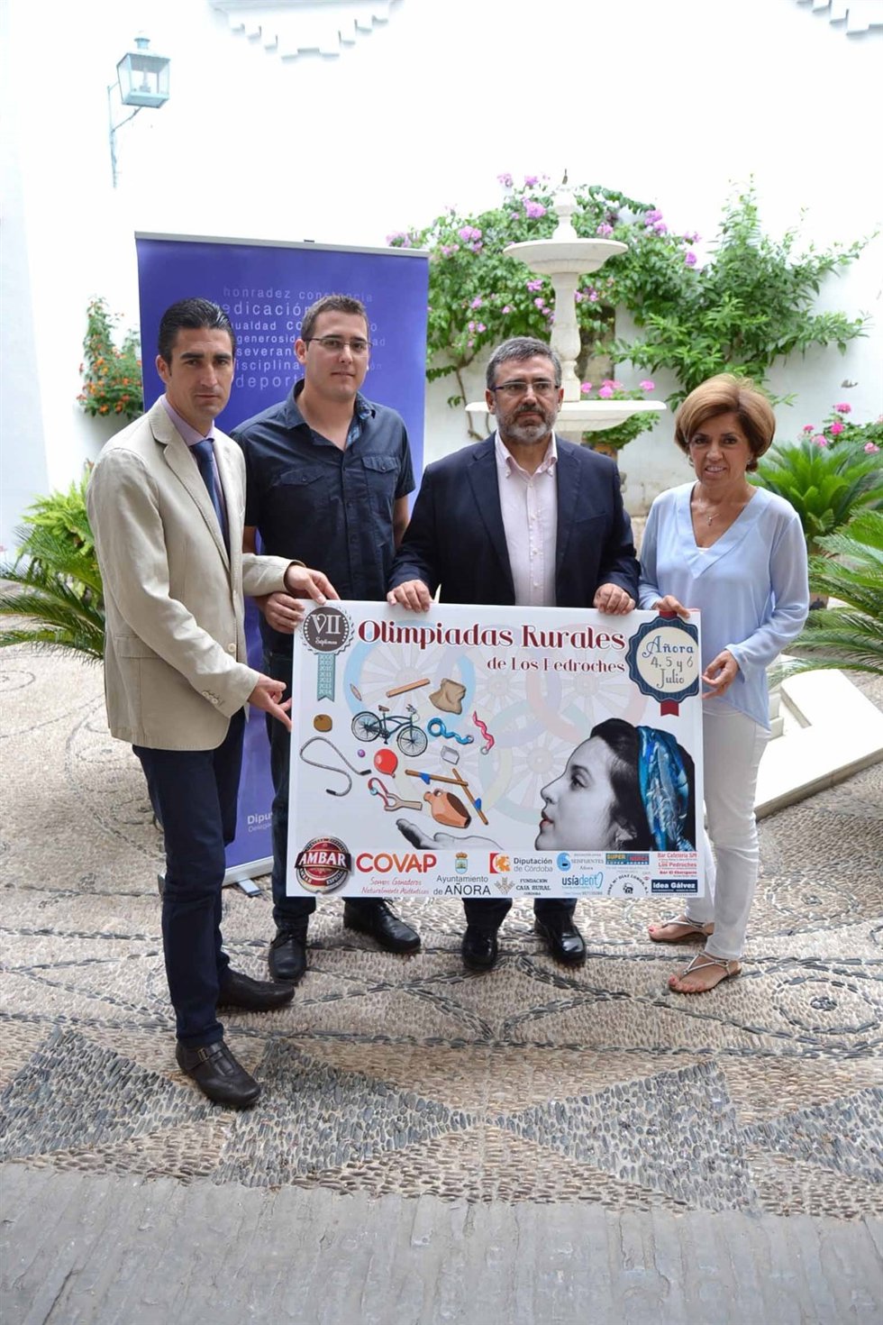 Palomares, Caballero, Madrid y Botella con el cartel de las olimpiadas