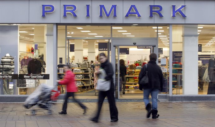 Pedestrians pass a Primark store in Loughborough, central England