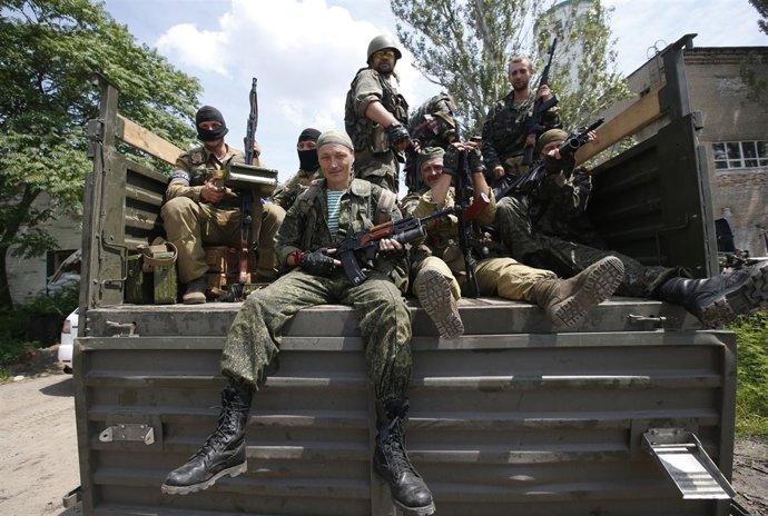 Pro-Russian separatist fighters from the so-called Battalion Vostok (East) sit i