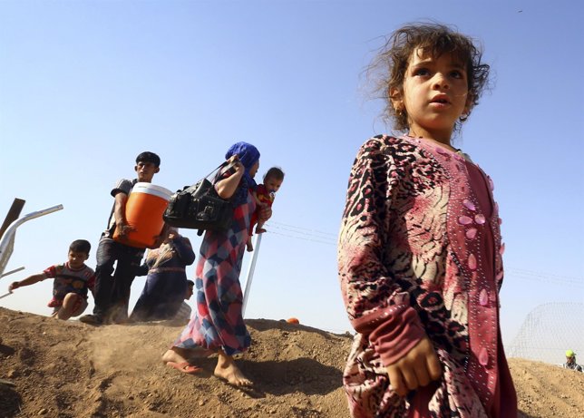 Niños huyendo de Mosul, Irak