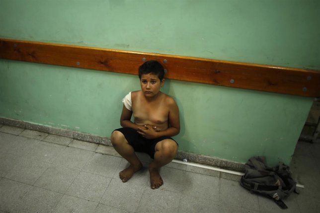 A Palestinian boy sits at a hospital in the northern Gaza Strip