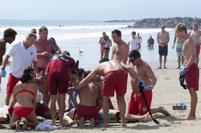 Lifeguards prepare to move a victim of a lightning strike in Venice, California