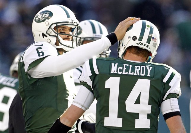 New York Jets quarterback Sanchez pats quarterback McElroy on helmet after scori