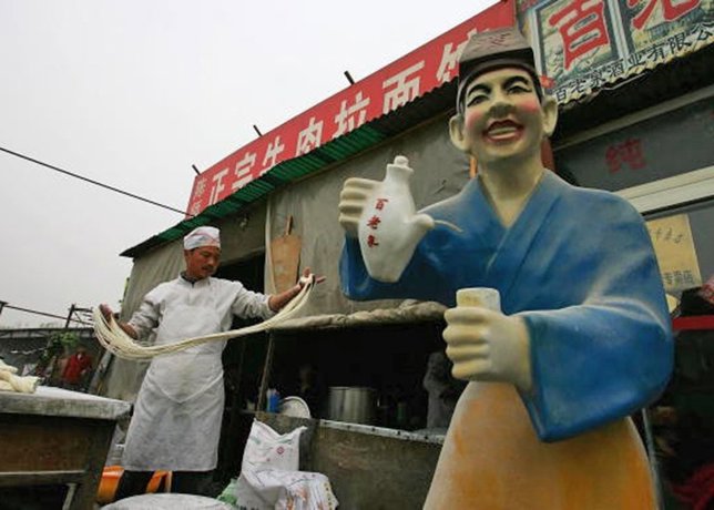 A Chinese chef makes noodles at a market on April 11, 2007 i