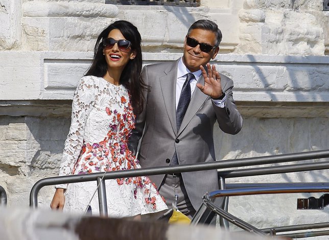 U.S. Actor George Clooney and his wife Amal Alamuddin leave the seven-star hotel