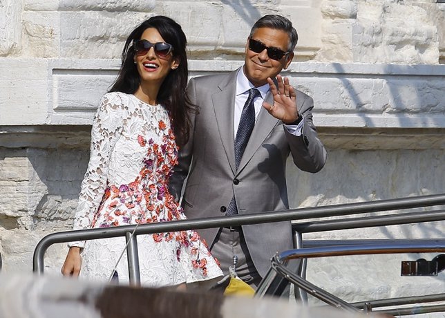 U.S. Actor George Clooney and his wife Amal Alamuddin leave the seven-star hotel