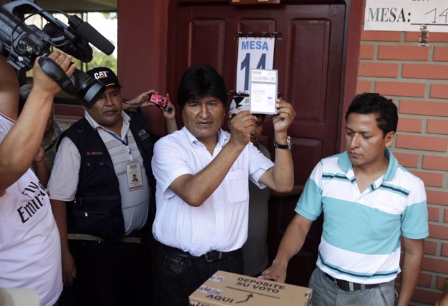 Bolivian President Evo Morales holds his ballot before voting in Villa 14 de Sep