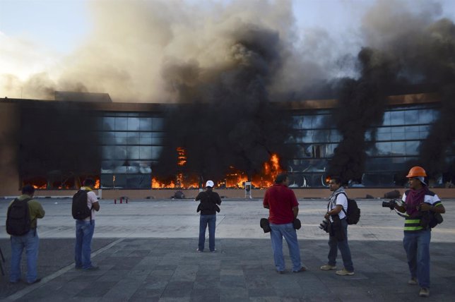 People look at the burning Chilpancingo City Hall, set on fire by demonstrators 