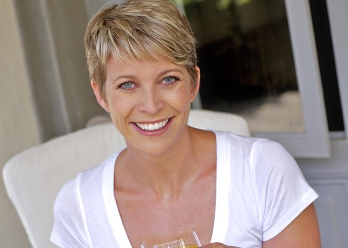 Mature woman enjoying orange juice and crossant