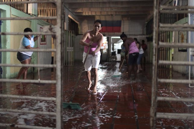 Inmates wash the floor in Cartagena's Women's District Jail in preparation for a