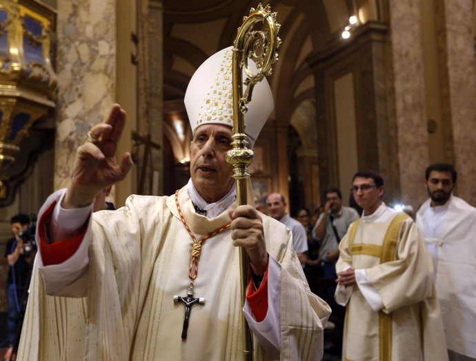 Cardinal Mario Aurelio Poli blesses the faithful during a mass to commemorate th
