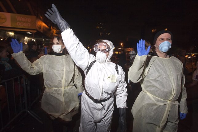 Participants dressed as Ebola workers take part in the Village Halloween Parade 