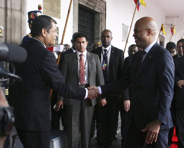 Ecuador's President Rafael Correa greets Haiti's President Michel Martelly durin