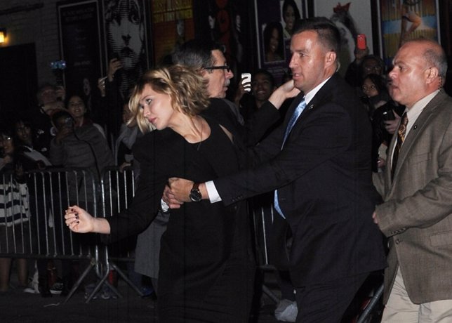 November 12 2014: Jennifer Lawrence rushes about in a disturbed fashion as she l