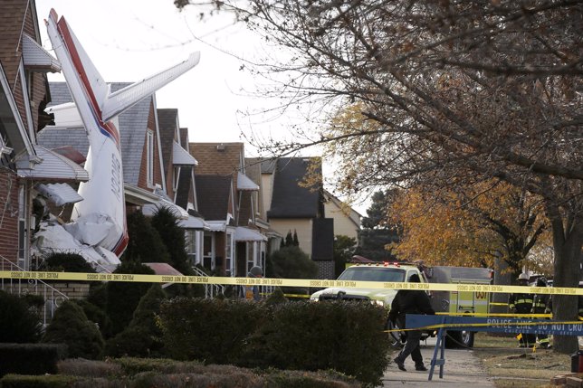 A small cargo plane is seen crashed into the side of a home in Chicago
