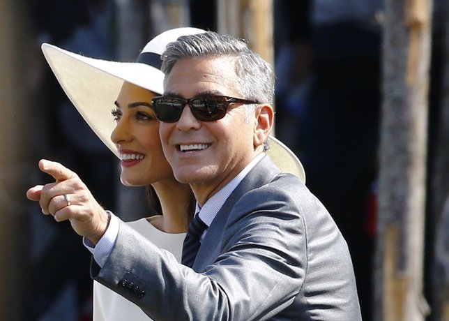 U.S. Actor George Clooney and his wife Amal Alamuddin leave Venice city hall aft