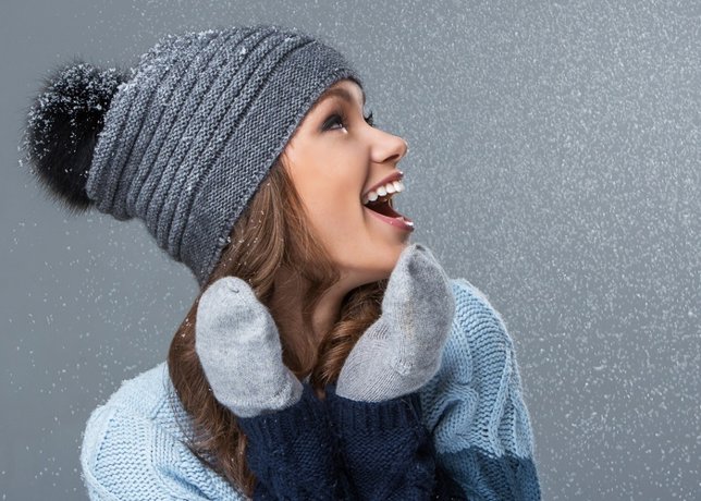 Cute girl is happy to see snowflakes