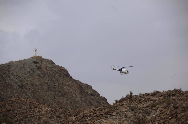 A helicopter of the U.S. Border patrol flies over the Sierra del Cristo Rey on t