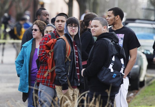 Students wait for parents outside the Rosemary Anderson High School in Portland,