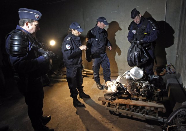 French policemen inspect a garage box during a control operation in apartment ho