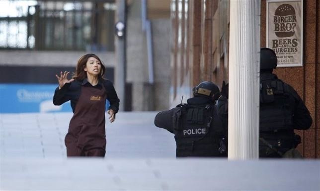 Una de las rehenes corre a manos de la policía en Sidney