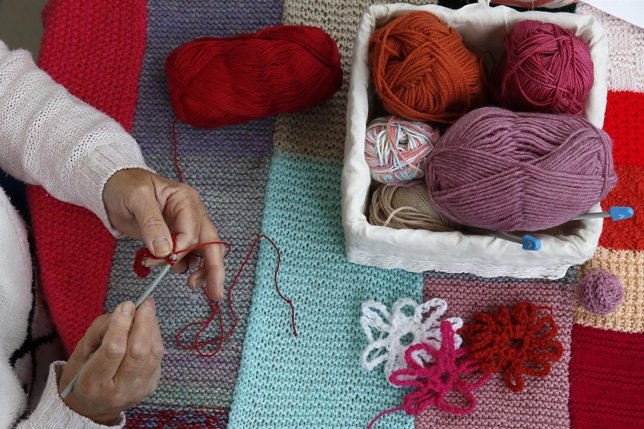 A woman knits during the Knitting and Stitching show at Alexandra Palace in Lond