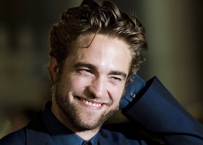 Actor Robert Pattinson poses for photographs on the red carpet for the new movie