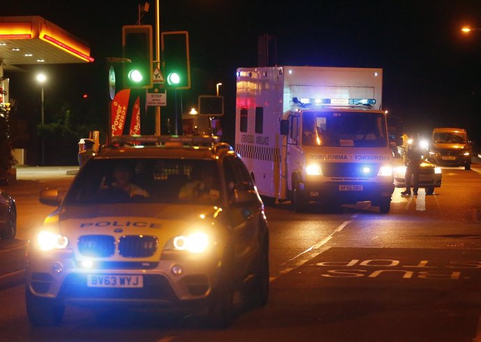 Police escort a RAF ambulance carrying a British man infected with Ebola virus a