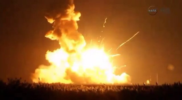 An unmanned Antares rocket is seen exploding seconds after lift off from a comme