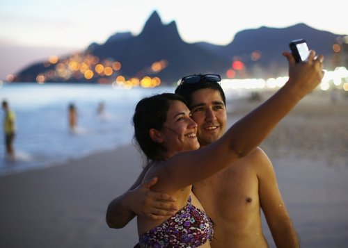 A couple takes a selfie photo on Ipanema beac