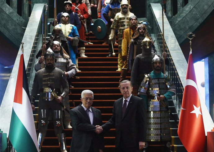 Turkey's President Tayyip Erdogan shakes hands with Palestinian President Mahmou