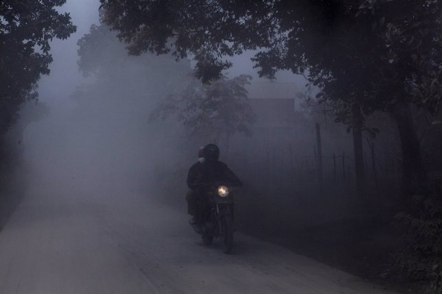 BERASTAGI, NORTH SUMATRA, INDONESIA - OCTOBER 11: A Motorcyclist Cover His Face 