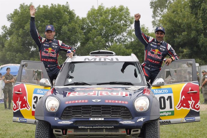Mini driver Al-Attiyah of Qatar and co-pilot Baumel of France celebrate after wi