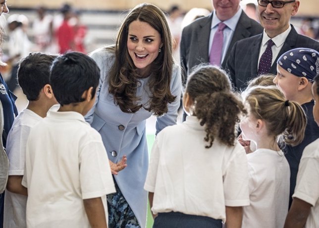 The Duchess of Cambridge talks to local school children during her visit to Kens