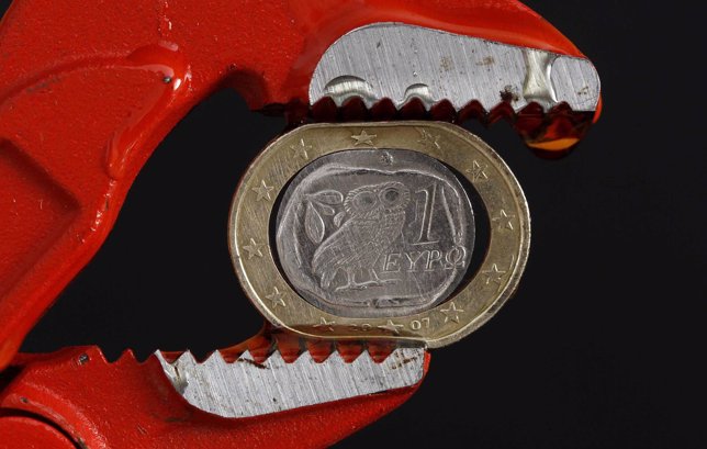 A Greek one Euro coin is squeezed by the teeth of a pair of grips in this photo 