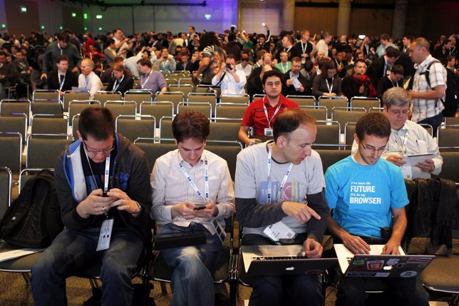 Google employees keep themselves busy before the keynote address at the Google I